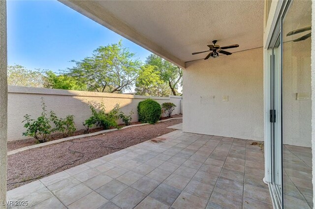 8052 Marbella Cir, Las Vegas, NV 89128 - fenced backyard with a ceiling fan and a patio area