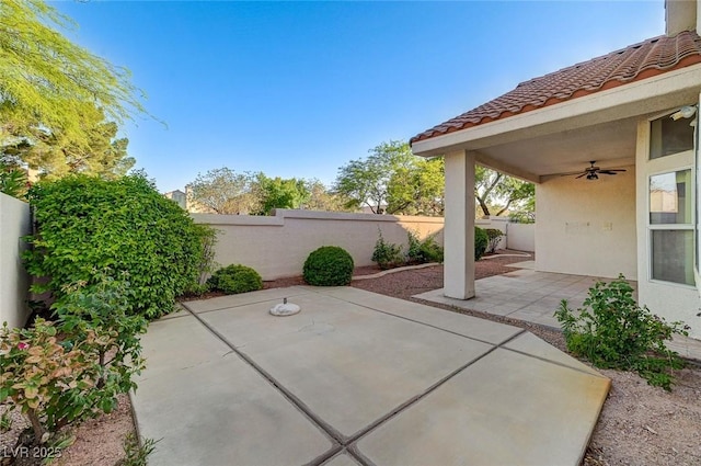 8052 Marbella Cir, Las Vegas, NV 89128 - fenced backyard with ceiling fan and a patio area