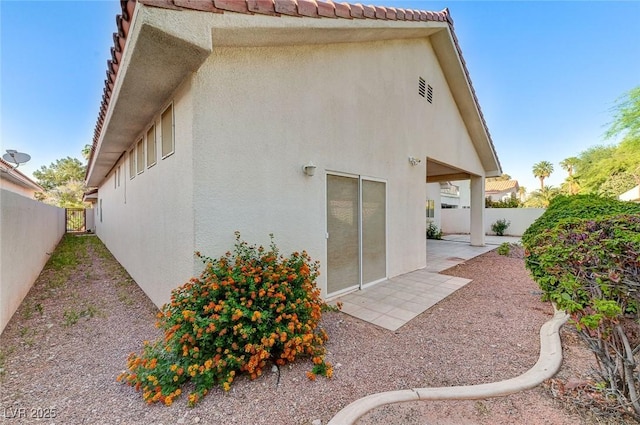 8052 Marbella Cir, Las Vegas, NV 89128 - back of property with stucco siding, a fenced backyard, a patio area, and a tiled roof