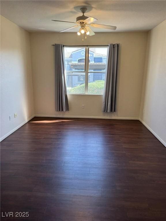 spare room with baseboards, ceiling fan, and wood finished floors