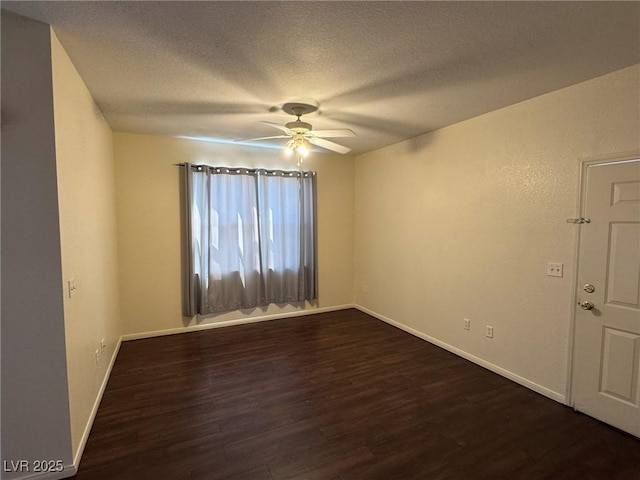 unfurnished room with baseboards, a ceiling fan, dark wood-style flooring, and a textured ceiling