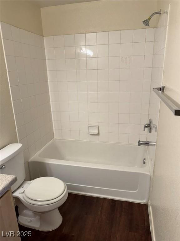 full bath featuring vanity, toilet, wood finished floors, and tub / shower combination