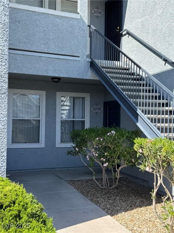 entrance to property with stucco siding