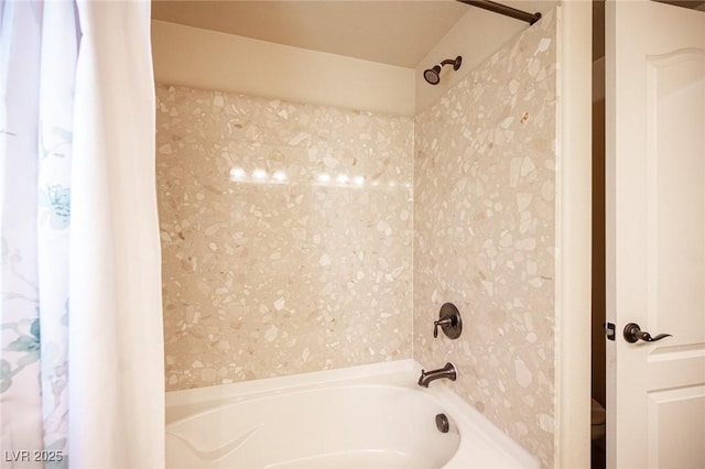 bathroom featuring wallpapered walls and shower / bathtub combination with curtain