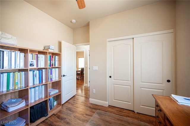 interior space featuring baseboards and wood finished floors