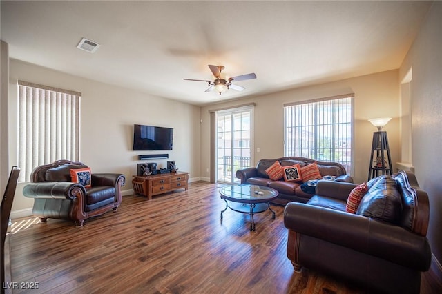 living room with visible vents, a ceiling fan, dark wood finished floors, and baseboards