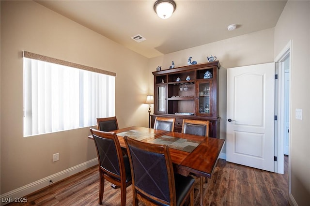 dining room with baseboards, wood finished floors, and visible vents