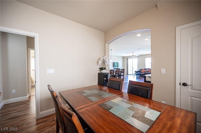 dining space with a ceiling fan, dark wood-style flooring, baseboards, recessed lighting, and arched walkways