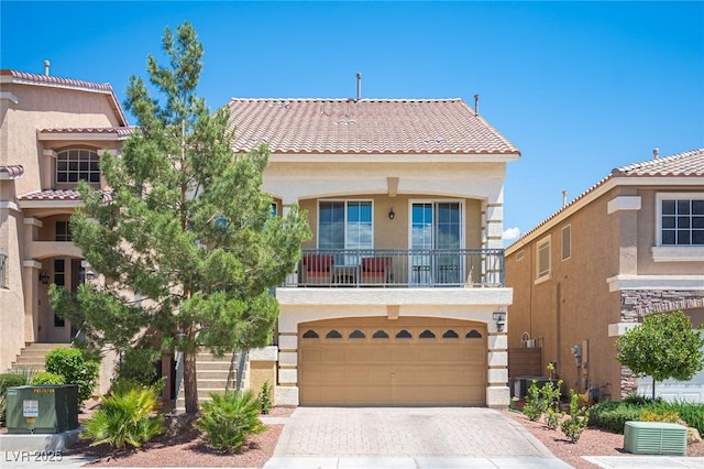 view of front of home with a garage, stucco siding, central AC unit, a tiled roof, and driveway