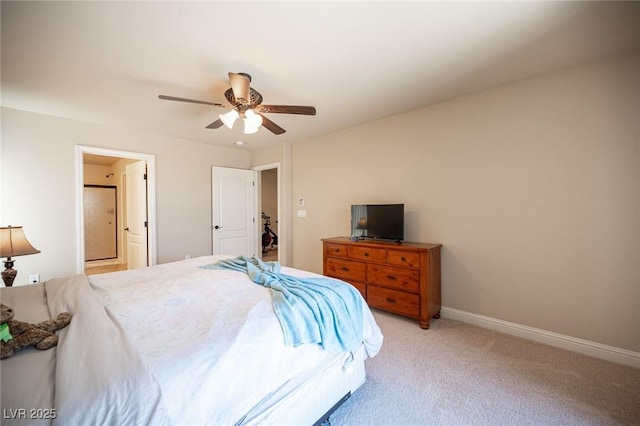 bedroom with baseboards, connected bathroom, ceiling fan, and light carpet