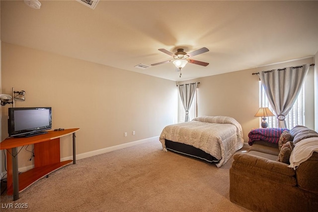 carpeted bedroom featuring baseboards, a ceiling fan, and visible vents