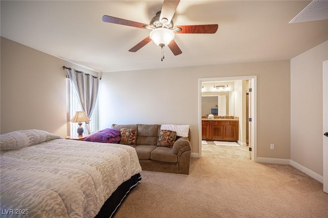 bedroom with ceiling fan, light colored carpet, ensuite bath, baseboards, and visible vents