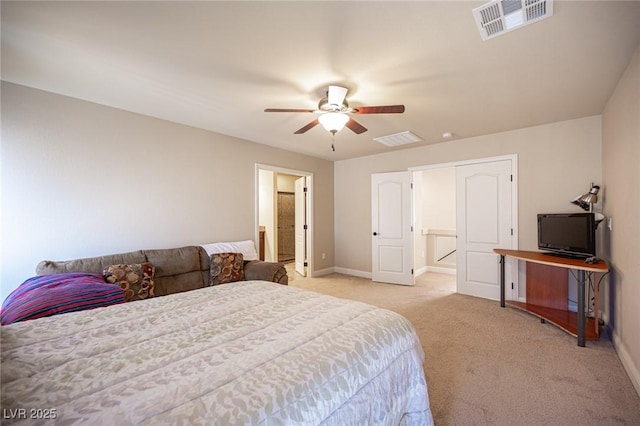 bedroom with baseboards, light carpet, connected bathroom, and visible vents
