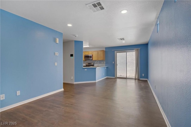9932 Keephills St, Las Vegas, NV 89183 - unfurnished living room featuring visible vents, recessed lighting, baseboards, and dark wood-style floors