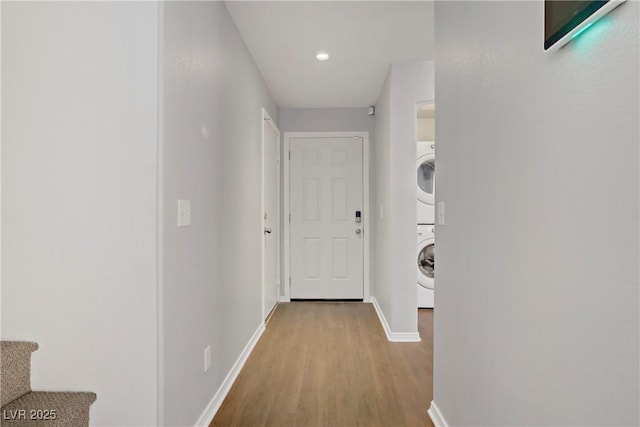 9932 Keephills St, Las Vegas, NV 89183 - hallway with baseboards, recessed lighting, stacked washer / dryer, and wood finished floors