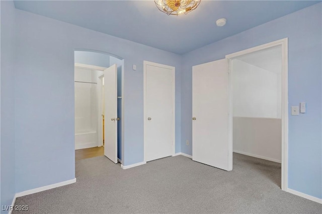 9932 Keephills St, Las Vegas, NV 89183 - unfurnished bedroom featuring baseboards, arched walkways, carpet flooring, and a closet