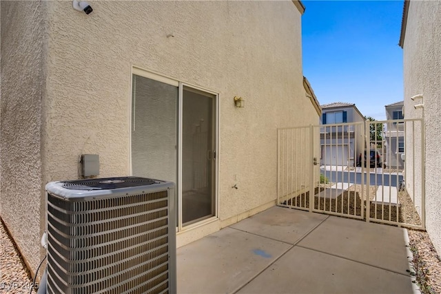 9932 Keephills St, Las Vegas, NV 89183 - view of patio / terrace featuring central air condition unit and a gate