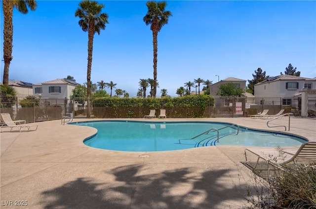 9932 Keephills St, Las Vegas, NV 89183 - community pool with a patio, fence, and a residential view