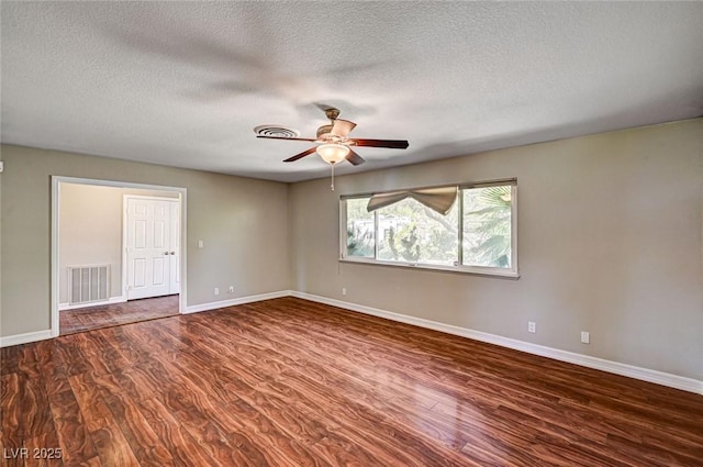unfurnished room featuring a textured ceiling, a ceiling fan, baseboards, wood finished floors, and visible vents