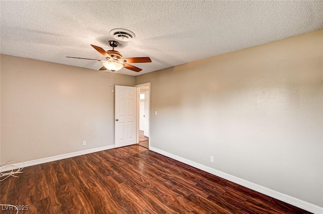 spare room with a ceiling fan, baseboards, visible vents, and wood finished floors