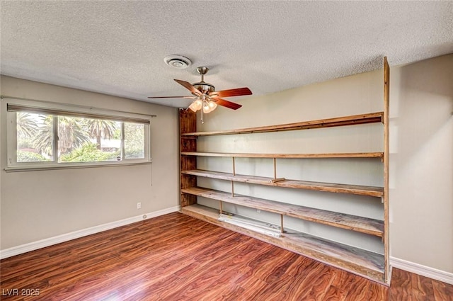 interior space featuring a ceiling fan and visible vents