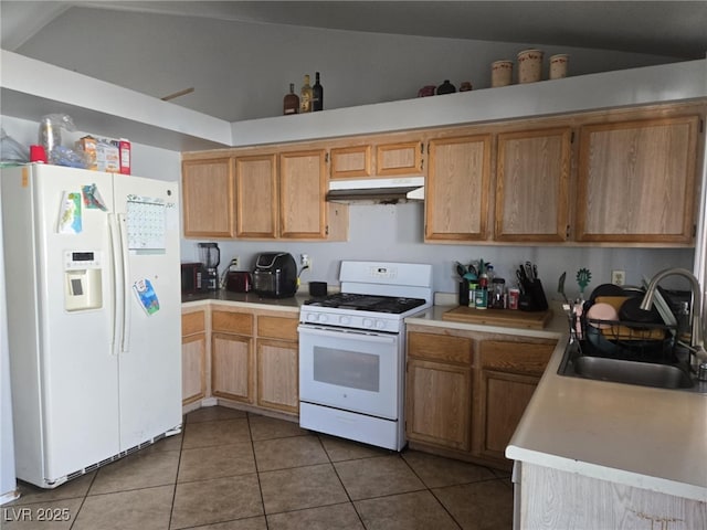 3512 Trilogy Dr, Las Vegas, NV 89108 - kitchen featuring a sink, tile patterned floors, light countertops, under cabinet range hood, and white appliances