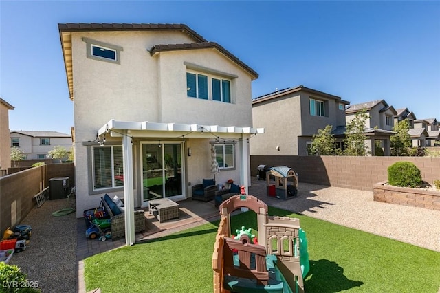 back of property with a fenced backyard, a pergola, stucco siding, and a patio