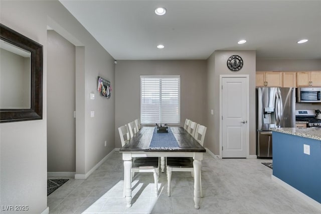 dining space with recessed lighting, baseboards, and light tile patterned flooring