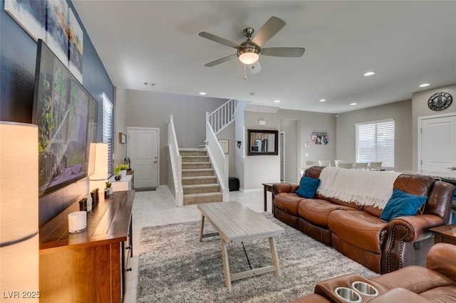 living room featuring recessed lighting, baseboards, ceiling fan, and stairway