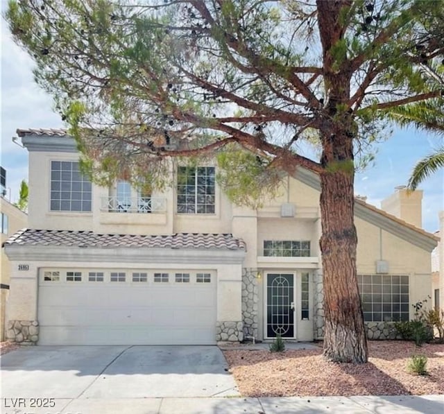 traditional home with a garage, stone siding, stucco siding, concrete driveway, and a tile roof