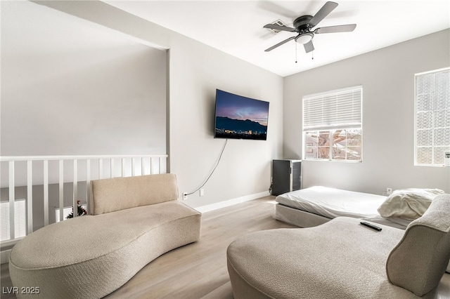 bedroom featuring baseboards, ceiling fan, and wood finished floors