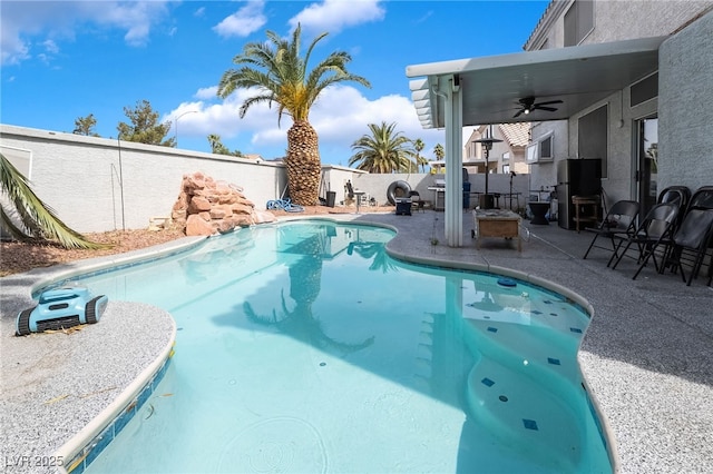 view of swimming pool with a fenced in pool, a ceiling fan, fence private yard, and a patio area
