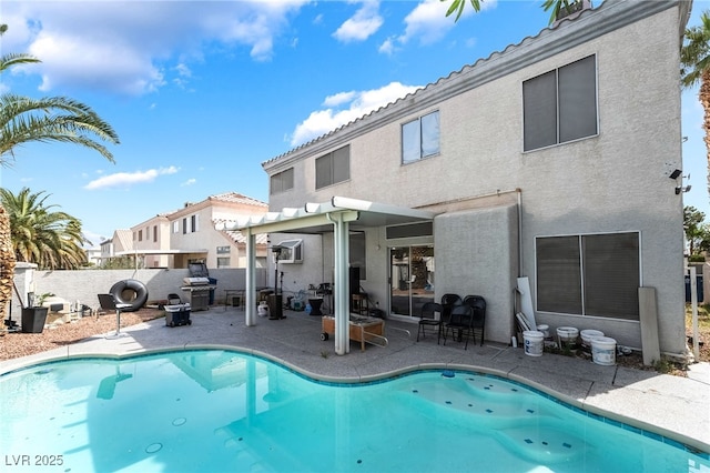 back of property featuring a fenced in pool, a fenced backyard, a patio area, and stucco siding