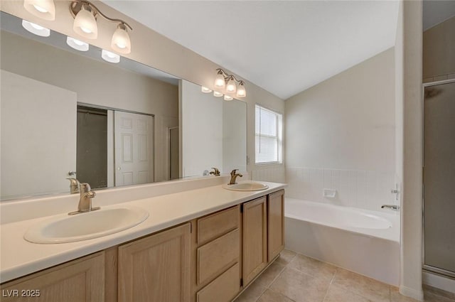bathroom with a sink, a garden tub, and a stall shower