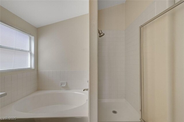 bathroom featuring a garden tub and a stall shower