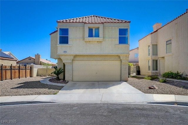 view of front of home featuring a tiled roof, a garage, fence, concrete driveway, and stucco siding