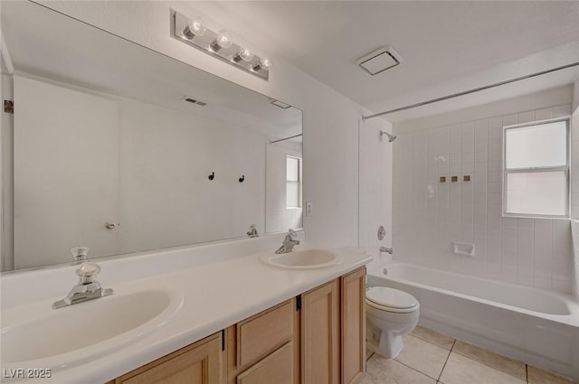 bathroom with a sink, tile patterned flooring, toilet, and shower / bath combination