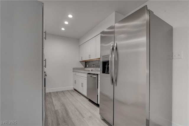 4432 Ash Ave, Las Vegas, NV 89110 - kitchen with a sink, light wood-type flooring, light countertops, white cabinets, and appliances with stainless steel finishes