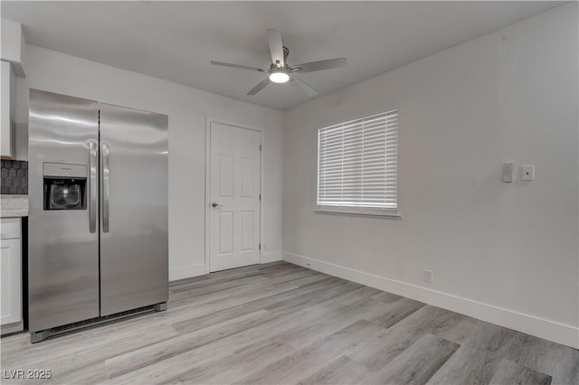 4432 Ash Ave, Las Vegas, NV 89110 - kitchen featuring stainless steel fridge, a ceiling fan, light wood-type flooring, baseboards, and tasteful backsplash