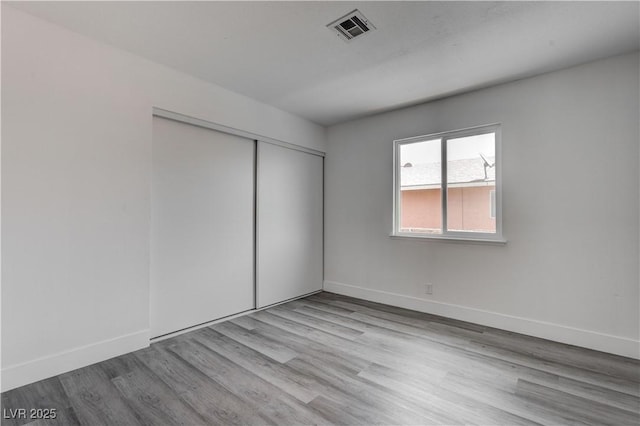 4432 Ash Ave, Las Vegas, NV 89110 - unfurnished bedroom with baseboards, visible vents, and wood finished floors