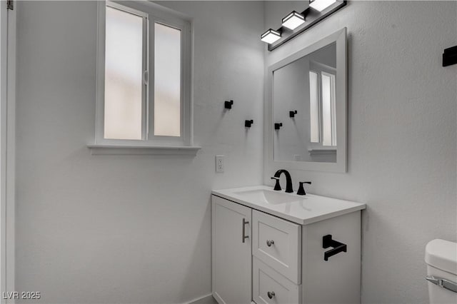 4432 Ash Ave, Las Vegas, NV 89110 - bathroom featuring toilet, vanity, and plenty of natural light