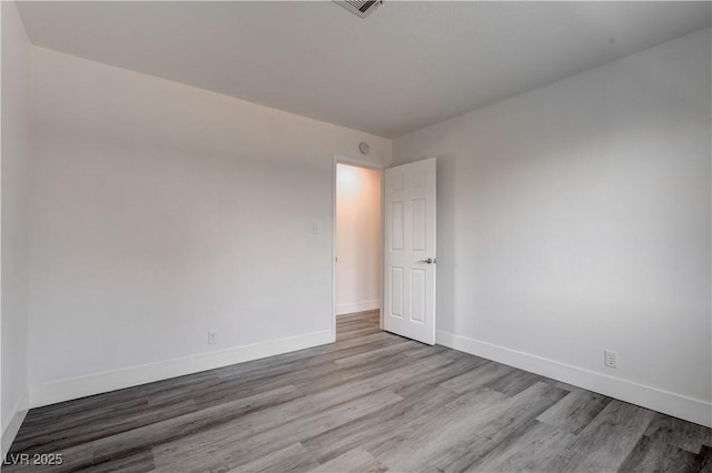 4432 Ash Ave, Las Vegas, NV 89110 - unfurnished room with baseboards, visible vents, and wood finished floors