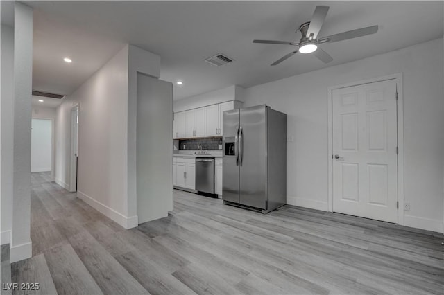4432 Ash Ave, Las Vegas, NV 89110 - kitchen with a ceiling fan, light wood finished floors, visible vents, white cabinetry, and appliances with stainless steel finishes