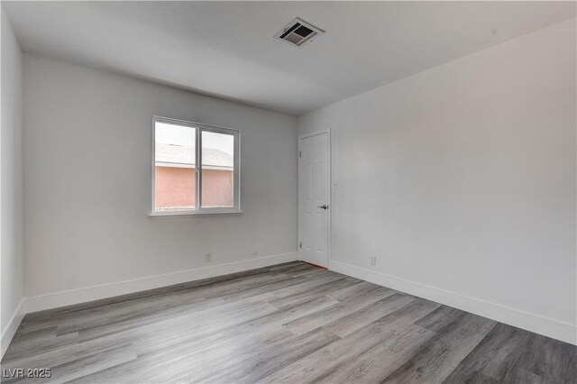 4432 Ash Ave, Las Vegas, NV 89110 - spare room with baseboards, visible vents, and wood finished floors
