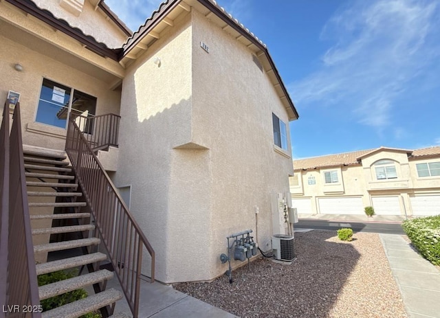 4941 Black Bear Rd Unit 202, Las Vegas, NV 89149 - view of side of property featuring central air condition unit, stucco siding, and stairway