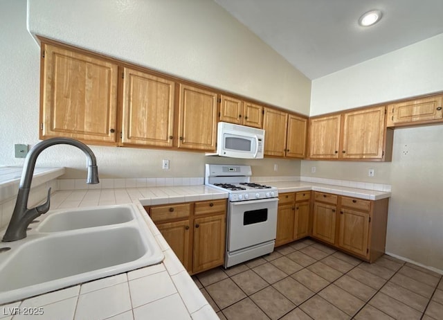 4941 Black Bear Rd Unit 202, Las Vegas, NV 89149 - kitchen featuring a sink, white appliances, tile counters, high vaulted ceiling, and light tile patterned floors