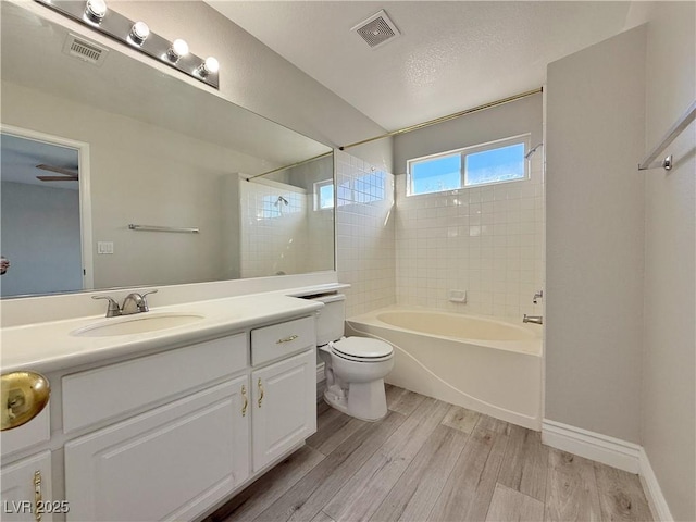 full bathroom with toilet, visible vents, wood finished floors, and vanity