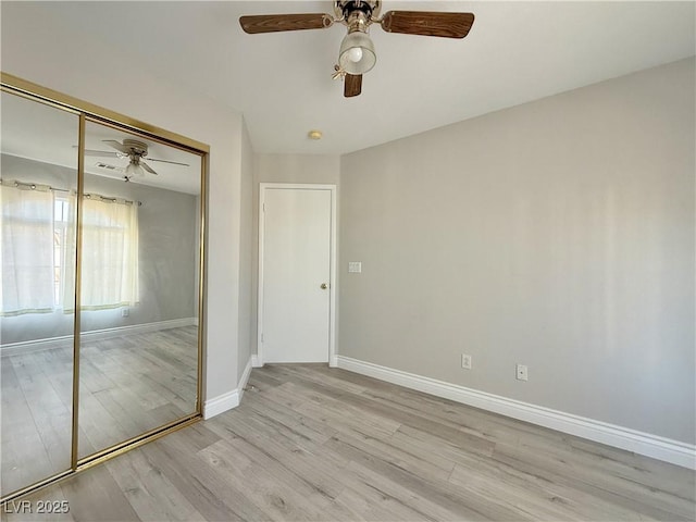 unfurnished bedroom with a closet, baseboards, ceiling fan, and wood finished floors