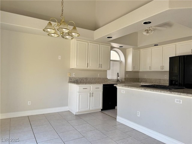 kitchen featuring a sink, white cabinets, a notable chandelier, and black appliances