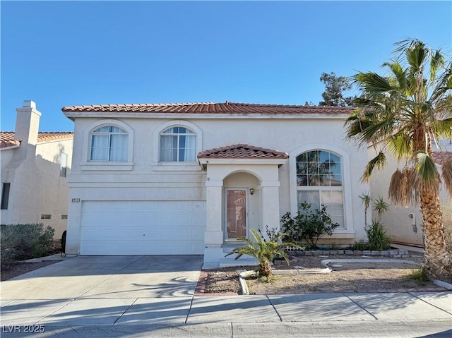 mediterranean / spanish-style house with a tiled roof, an attached garage, driveway, and stucco siding